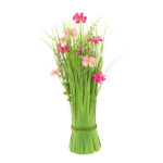 Bundle of grass with spring flowers out of...