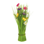 Bundle of grass with spring flowers out of...